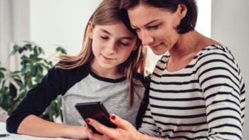 Mom and daughter looking at a cell phone
