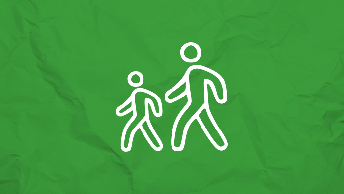 Two white stick figures walking on a green, crumpled background.