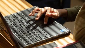 Fingers typing on a laptop