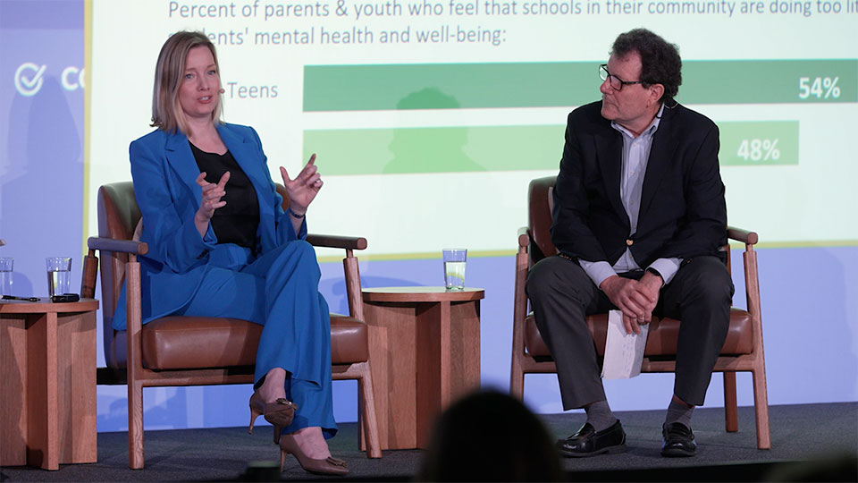 Kristen Soltis Anderson and Nick Kristof seated on stage