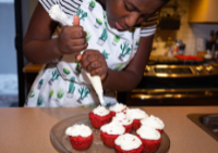 image of young girl making red velvet cupcakes
